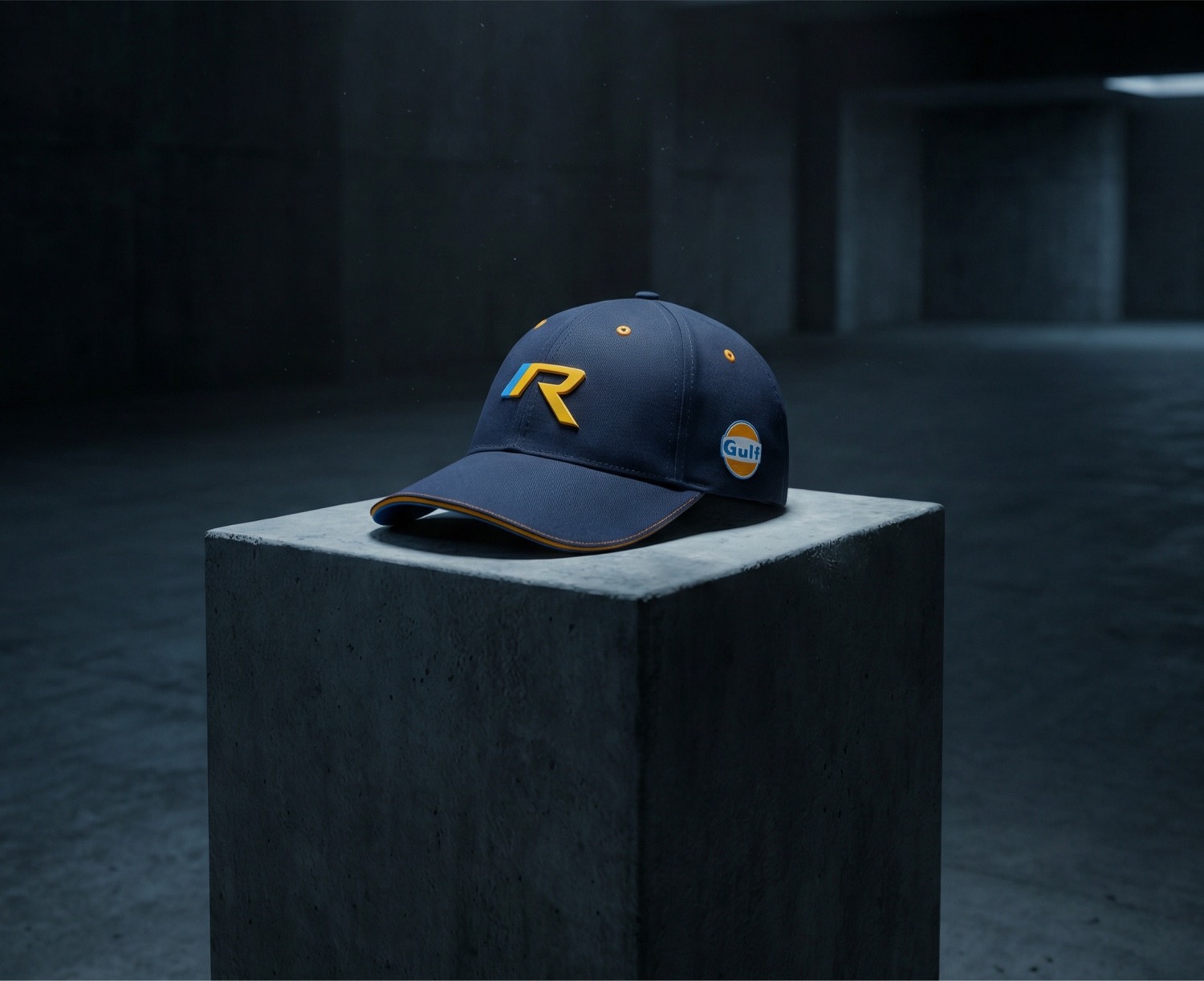 Navy cap with gold R logo on a concrete plinth